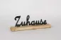 Preview: Moderner Metall-Schriftzug Zuhause auf Kommode platziert