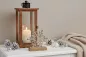 Preview: Schneeflocke aus Metall auf Mangoholzsockel – elegante Winterdekoration